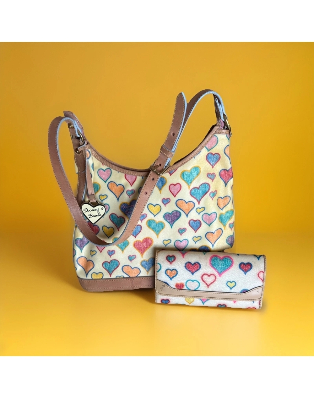 Dooney & Bourke Cream Shoulder Bag with Multicolor Heart Print and Tan Trim
